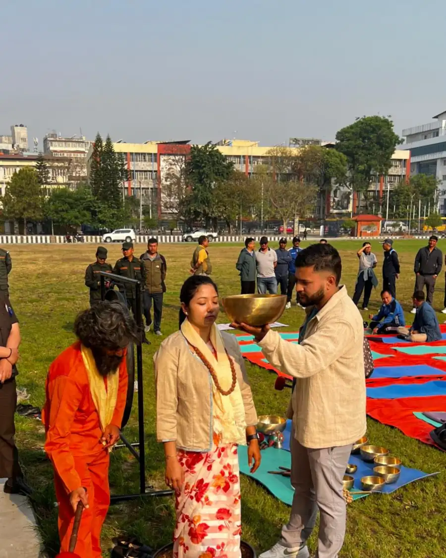 Yogi Ji being honoured with a garland and shawl at an outdoor wellbeing programme in Kathmandu